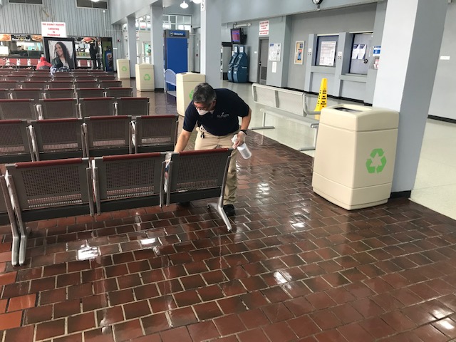 Shore Line East employee wiping down station waiting area